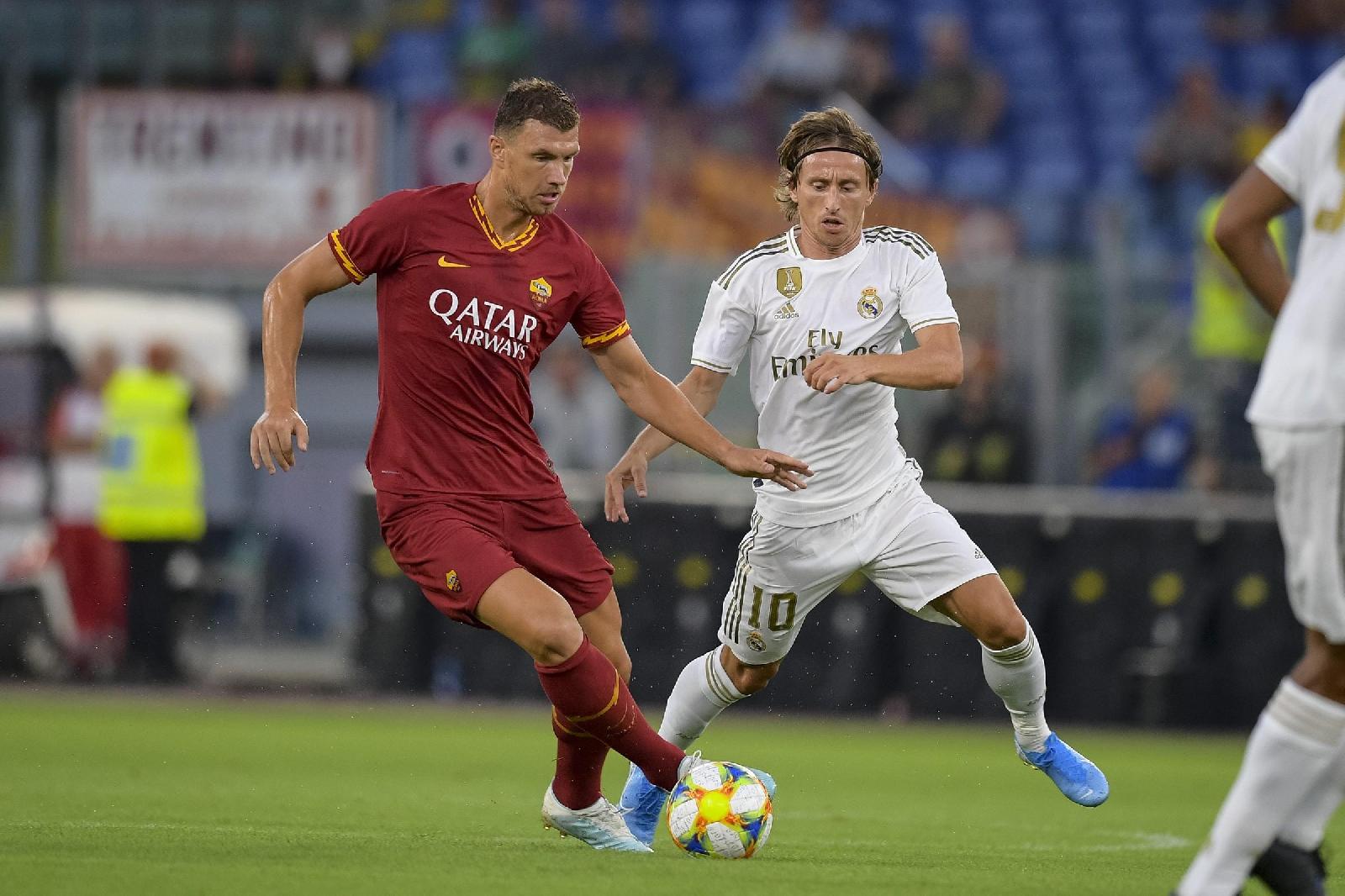 Dzeko e Modric in azione, di LaPresse